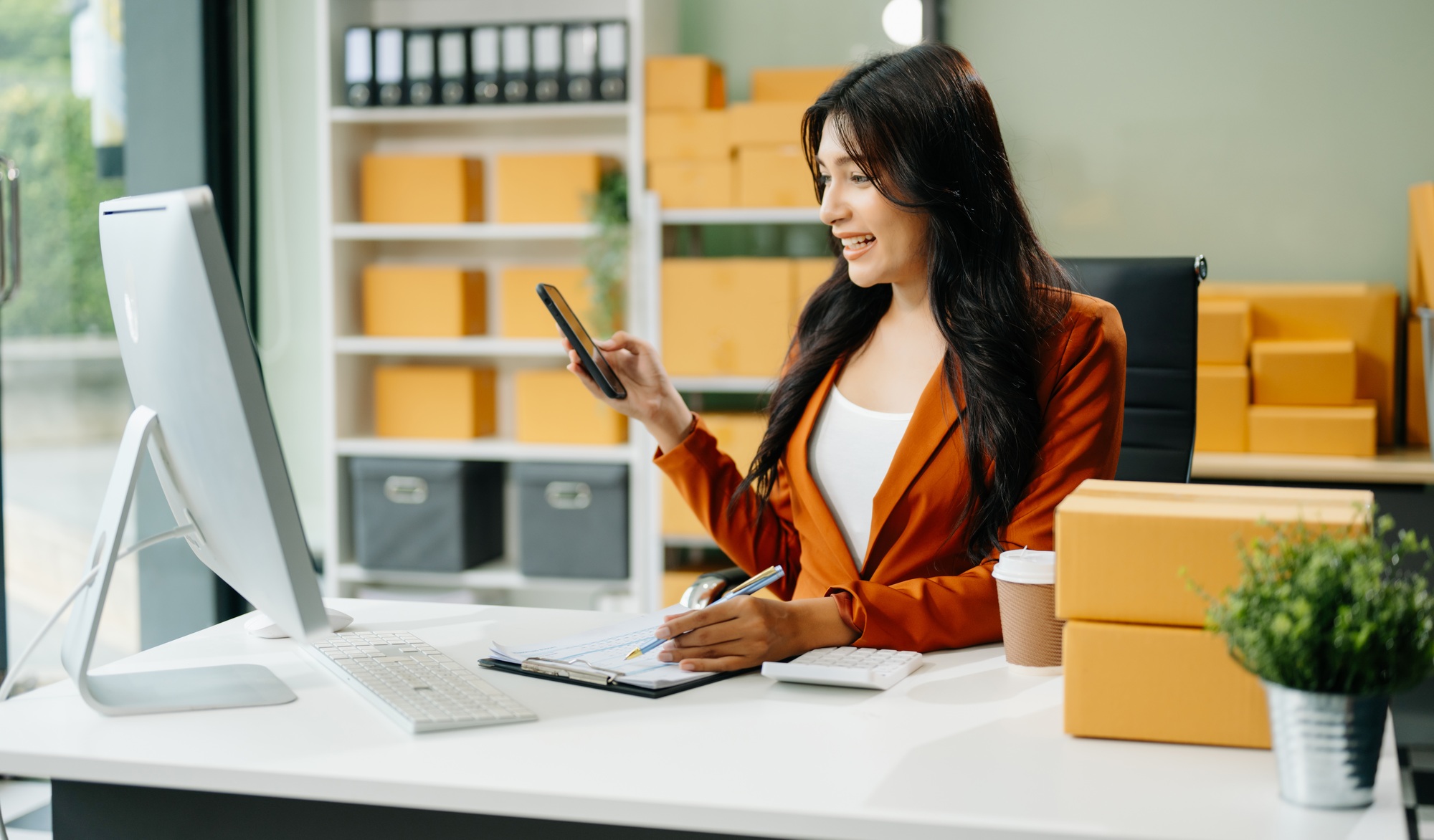 Woman Entrepreneur: SME Business mastering e-commerce with tablet, laptop, packaging,